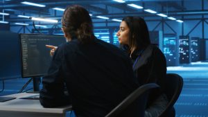 multiethnic colleagues overseeing supercomputers data center (1) copia