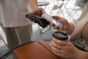 side view customer paying with nfc device